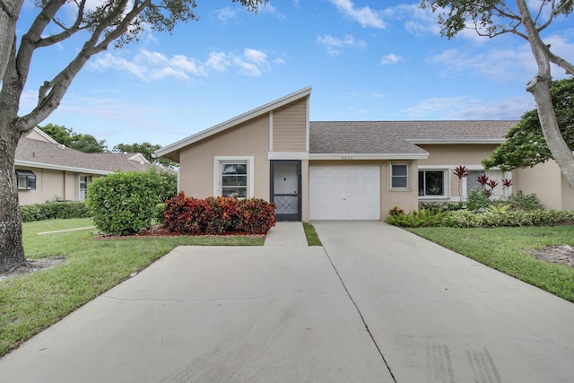 ranch-style home featuring a front lawn and a garage