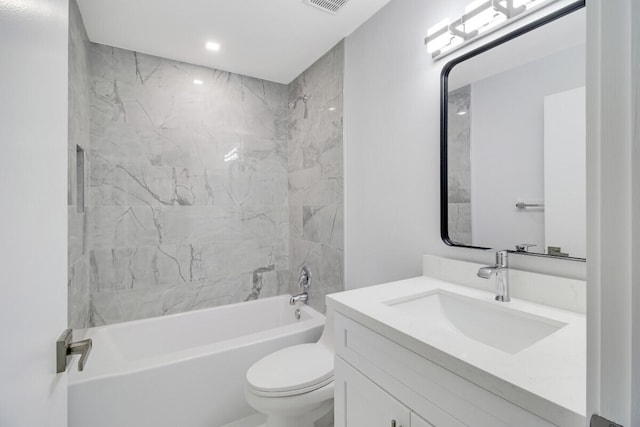 full bathroom featuring vanity, tiled shower / bath combo, and toilet