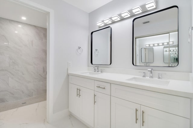 bathroom with vanity and a tile shower