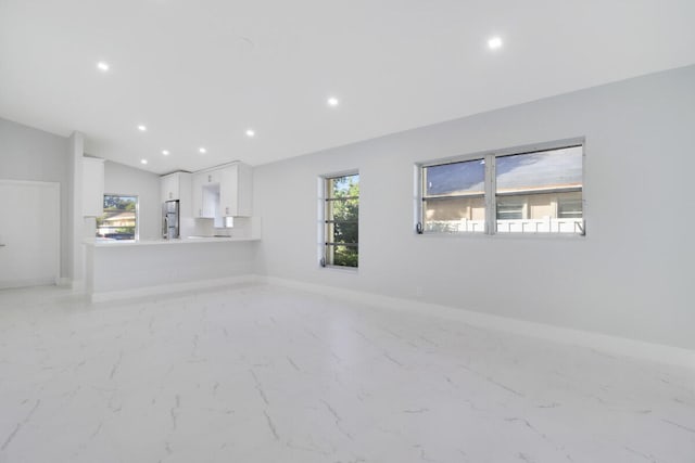 unfurnished living room with lofted ceiling