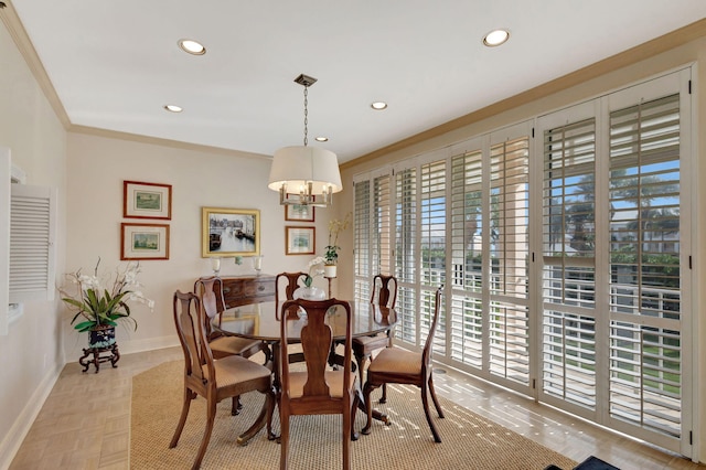 dining area with crown molding and a chandelier