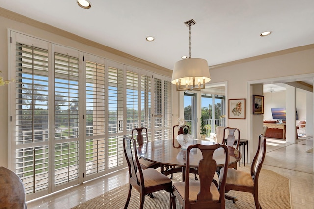 tiled dining space with a notable chandelier and ornamental molding