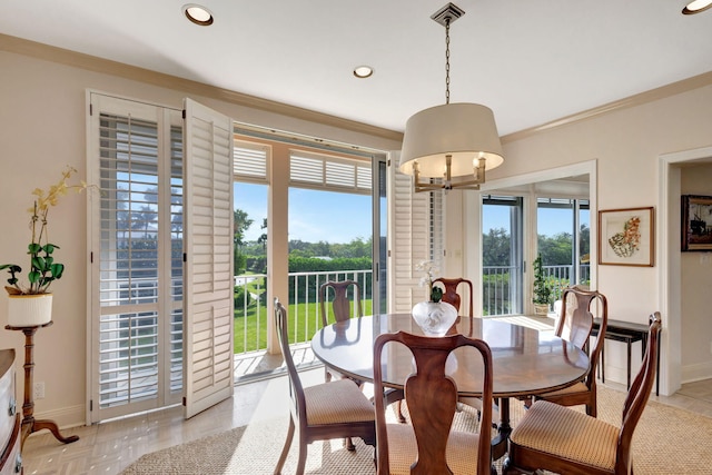 dining area featuring light parquet flooring and ornamental molding