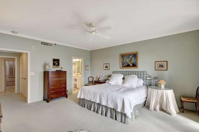 bedroom featuring crown molding, light colored carpet, connected bathroom, and ceiling fan