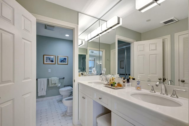 bathroom featuring vanity, toilet, and a bidet