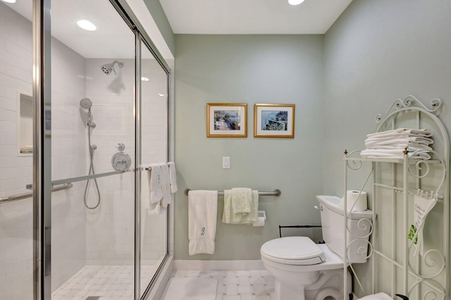 bathroom with a shower with door and toilet