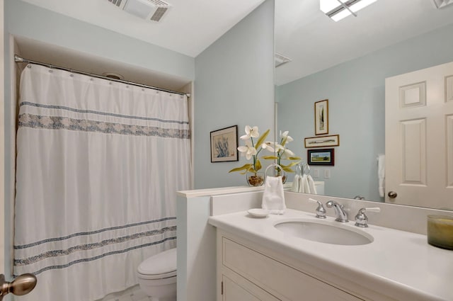 bathroom with vanity, toilet, and walk in shower