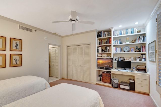 bedroom with light colored carpet, ornamental molding, built in desk, and ceiling fan