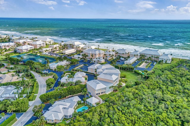 bird's eye view with a water view and a beach view