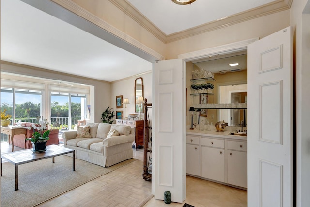 living room featuring ornamental molding, light parquet floors, and sink