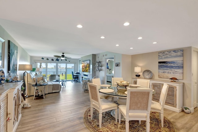 dining room featuring light hardwood / wood-style flooring and ceiling fan