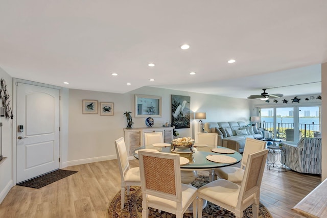 dining room with ceiling fan and light hardwood / wood-style flooring