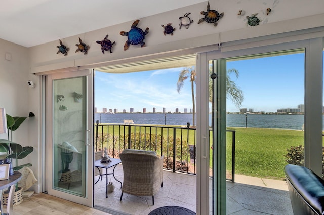 doorway to outside with plenty of natural light and a water view