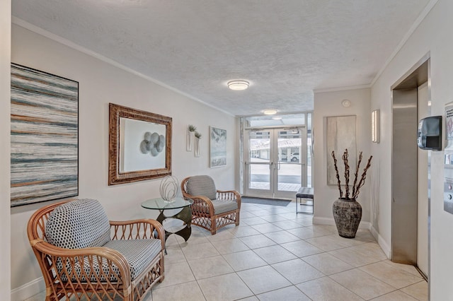 sitting room with ornamental molding, french doors, a textured ceiling, and light tile patterned floors