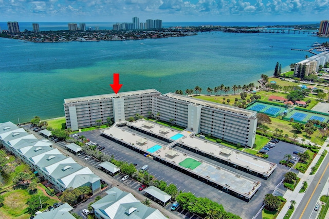 view of urban area featuring a nearby body of water and a pool area
