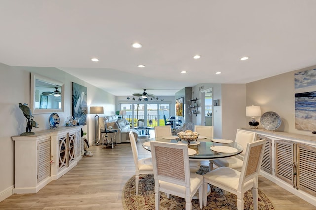 dining space with ceiling fan and light hardwood / wood-style flooring