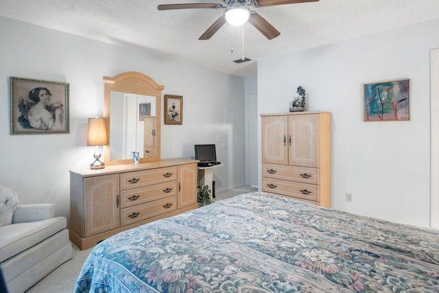 bedroom featuring light carpet, a textured ceiling, and ceiling fan