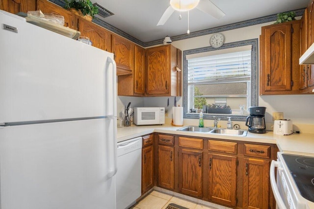 kitchen featuring sink, ceiling fan, white appliances, and light tile patterned floors