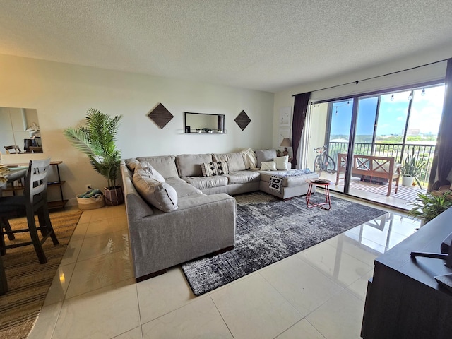 living room featuring a textured ceiling and tile patterned flooring