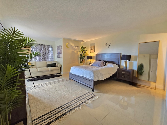 tiled bedroom featuring a textured ceiling