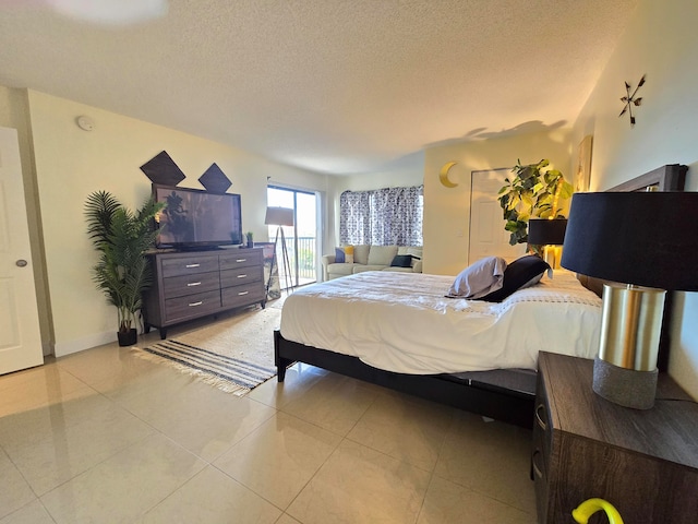 tiled bedroom with a textured ceiling