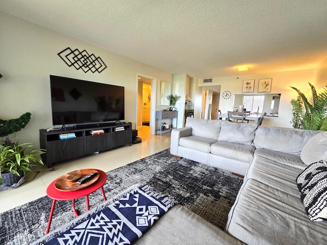 living room with a textured ceiling and tile patterned floors