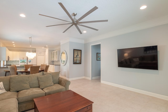 living room featuring crown molding and ceiling fan with notable chandelier