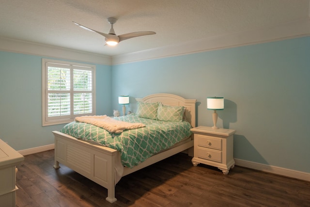 bedroom featuring dark wood-type flooring, crown molding, a textured ceiling, and ceiling fan