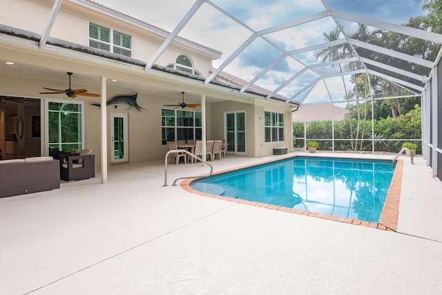 view of pool featuring a patio, ceiling fan, and glass enclosure