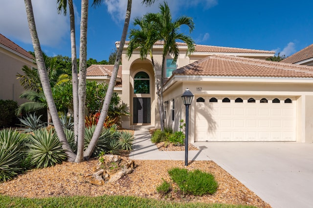 mediterranean / spanish-style home featuring a garage