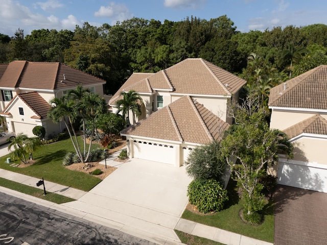 view of front of home featuring a front yard and a garage