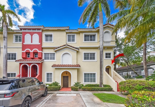 428 Bayfront Dr, Boynton Beach, FL 33435 - view of front of property with stucco siding, a tile roof, and uncovered parking