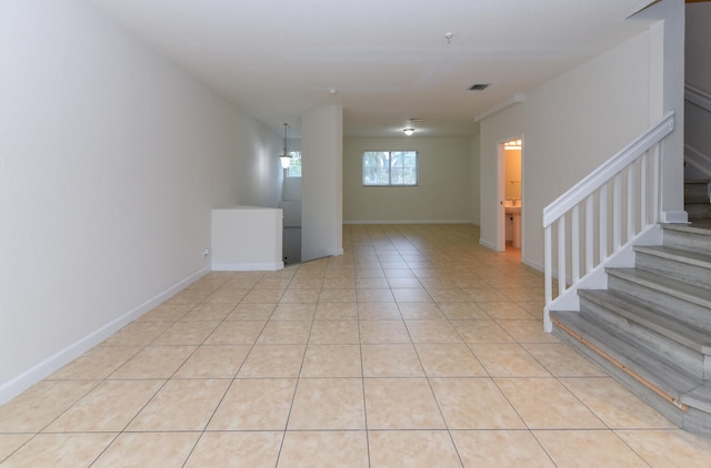 428 Bayfront Dr, Boynton Beach, FL 33435 - empty room with stairway, baseboards, and light tile patterned flooring