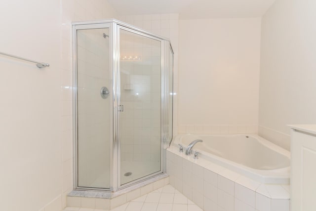 bathroom featuring vanity, independent shower and bath, and tile patterned flooring