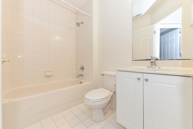 full bathroom with vanity, tiled shower / bath, toilet, and tile patterned flooring