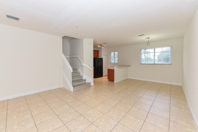 spare room with a notable chandelier