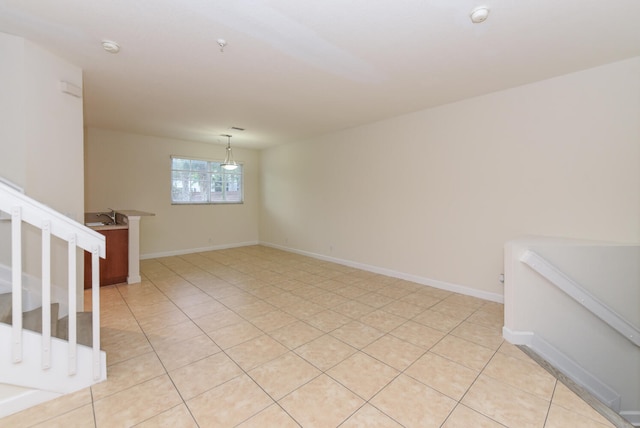 spare room featuring sink and light tile patterned flooring