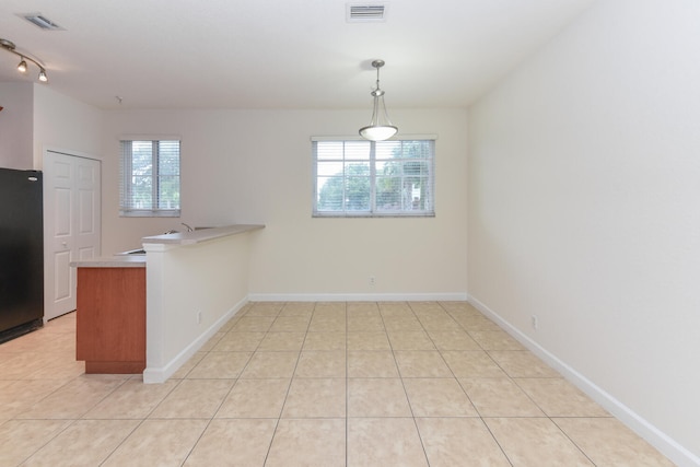 interior space with light tile patterned floors and plenty of natural light