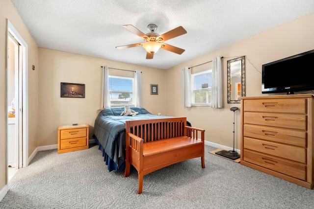 carpeted bedroom with a textured ceiling and ceiling fan