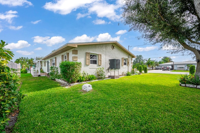 view of side of property with a yard