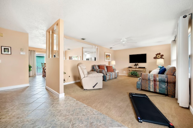 carpeted living room with a textured ceiling and ceiling fan