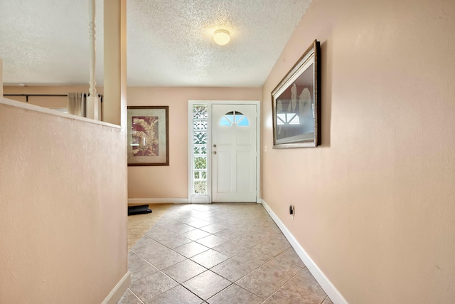 tiled entryway with a textured ceiling