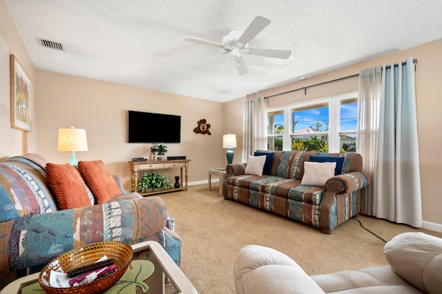 carpeted living room featuring a textured ceiling and ceiling fan