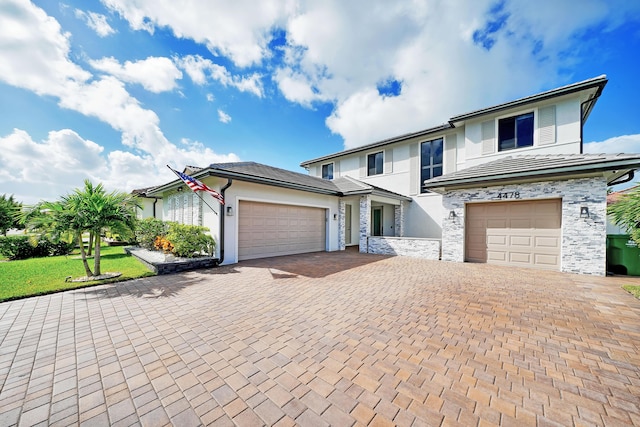 4478 SW 178th Ave Unit 4478, Miramar, FL 33029 - view of front of house with decorative driveway, stucco siding, stone siding, a garage, and a front yard