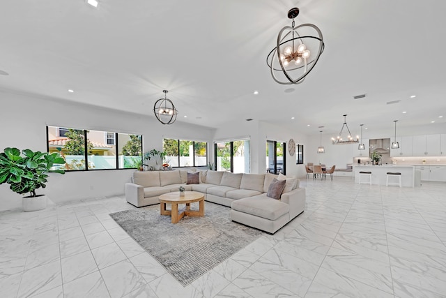 living room featuring a wealth of natural light and a notable chandelier