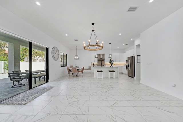 unfurnished dining area with an inviting chandelier