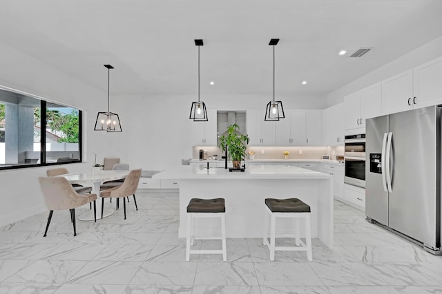 4478 SW 178th Ave Unit 4478, Miramar, FL 33029 - kitchen with stainless steel appliances, light countertops, light marble finish flooring, white cabinetry, and recessed lighting