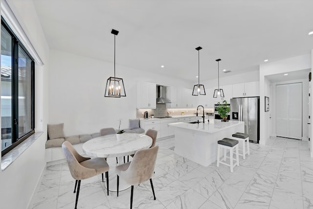 dining area with a notable chandelier and sink