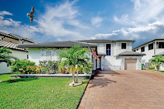 view of front of house featuring a garage and a front yard