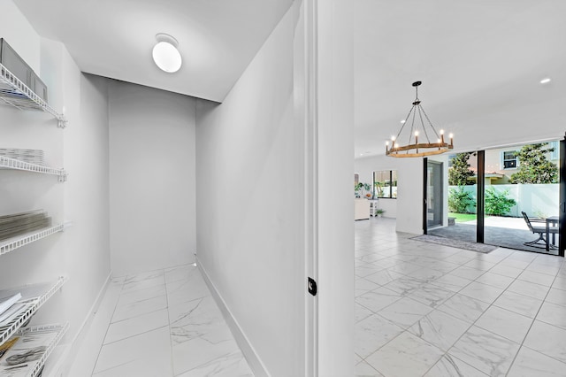 hallway featuring a chandelier